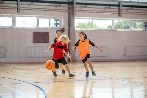 school_sports_hall_kids_playing_football.jpg